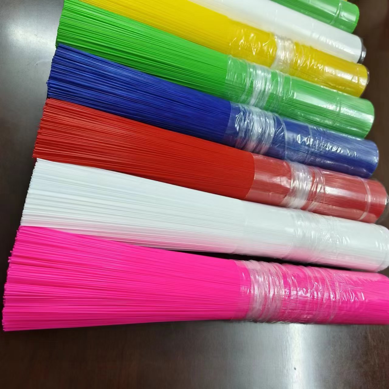 Custom colored broom filament rolls stacked