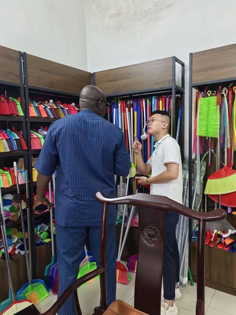 Sales engineer introducing broom products to a visiting buyer