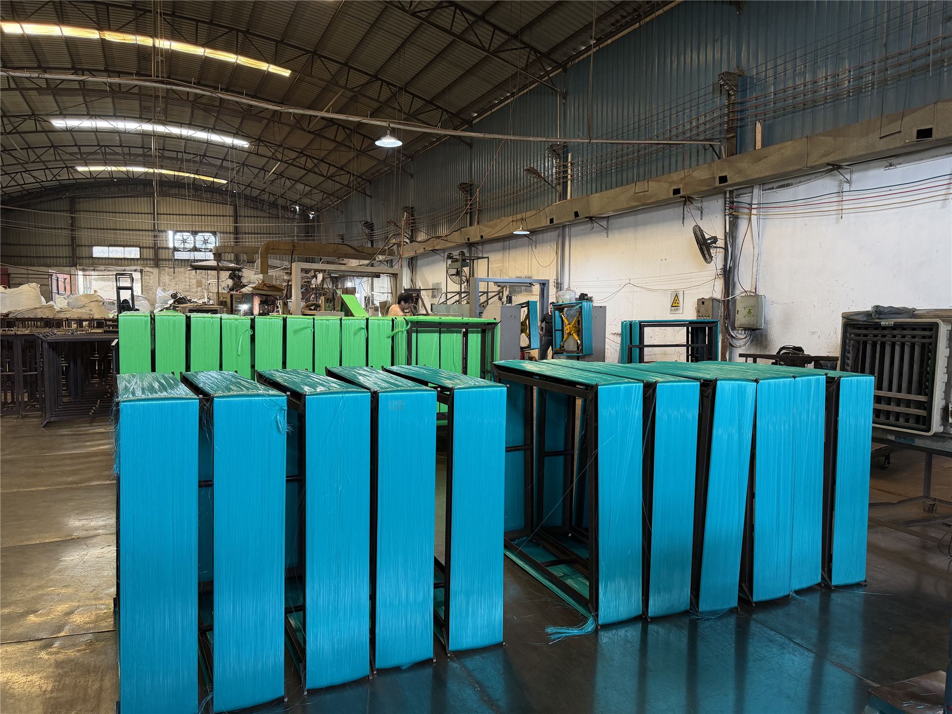 Cyan and green filament bundles on winding racks